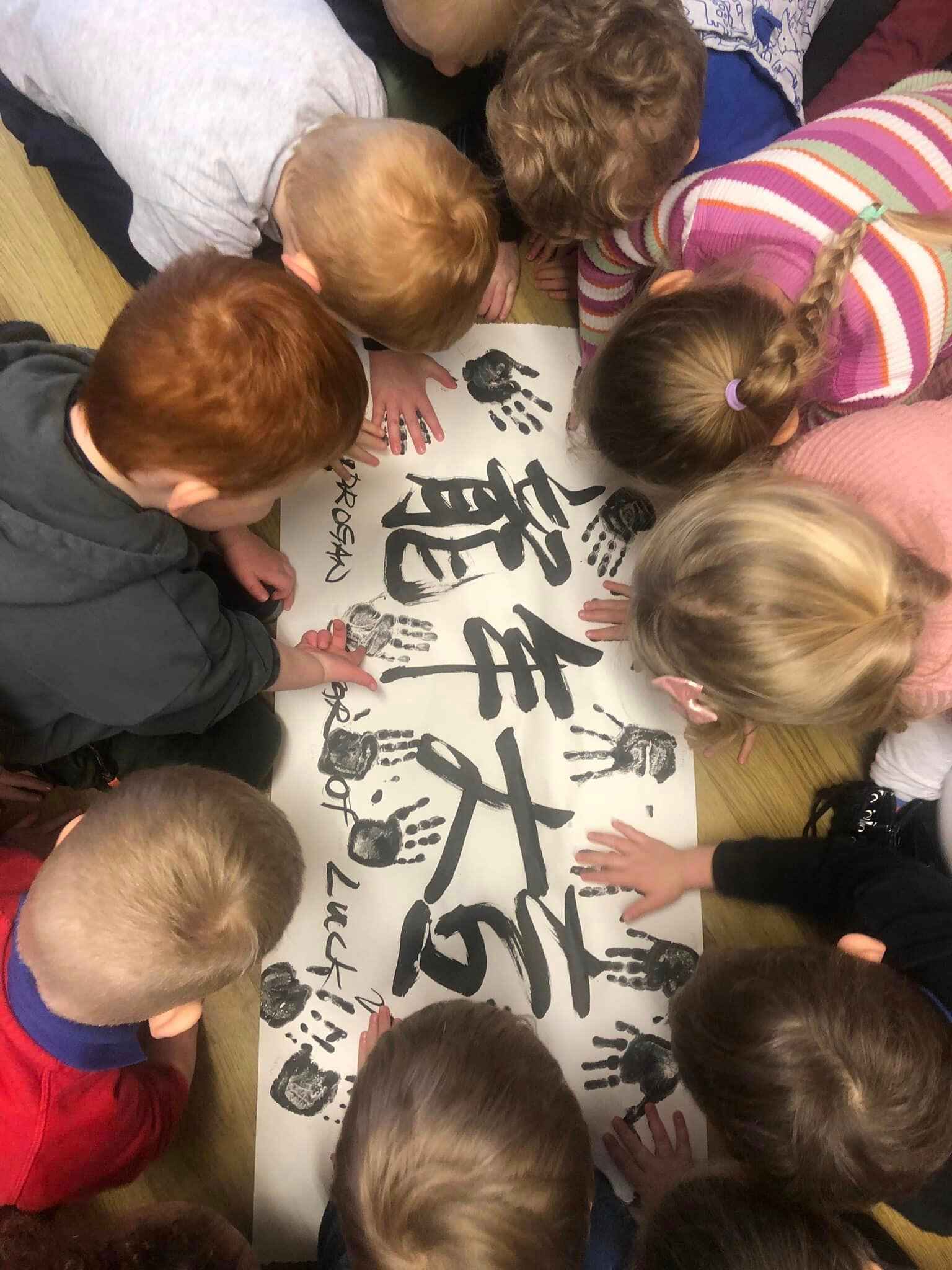 Children creating artwork with their hands